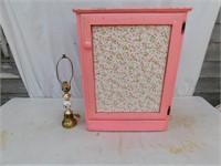 Pink cabinet plus small lamp