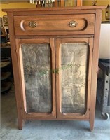 Antique pie safe cabinet with one drawer in the