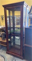 Tall display cabinet with six glass shelves.