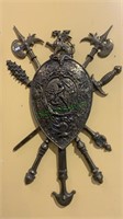Large molded brass wall shield with a griffin