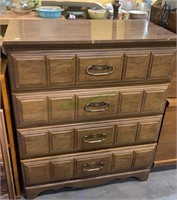 Four level four drawer tall dresser with a