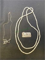 Jewelry lot includes a long strand of pearls,