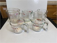 Group of five glass measuring cups