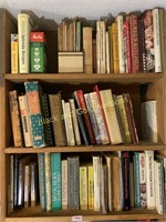 Three shelves of assorted cookbooks