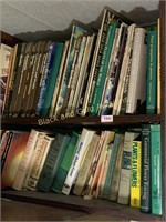 Two shelves of assorted gardening books