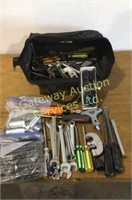 Tool satchel filled with tools. Wrenches,