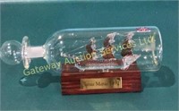 A glass ship in bottle made in Britain ship title
