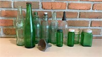Assorted green glass bottles/jars & funnel