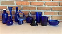 Assorted blue glass bottles, basket, vase,