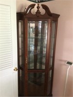 Lighted corner curio cabinet with glass shelves