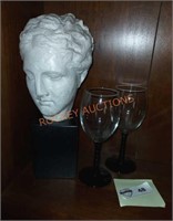 Sculpture head and wine glasses