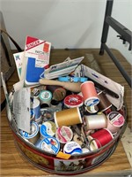 Tin of sewing thread & notions.