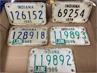 5 motorcycle license plates.