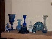 Blue glassware:   vases, bells, duck etc.