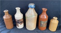 Lot of five antique stoneware bottles.