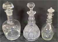 Lot of three glass decanters with stopper tops.