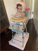 VTG BABY DOLL IN VTG AMSCO TOY HIGH CHAIR