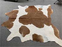Cowhide, Brown and White. Measures 87" x 79"