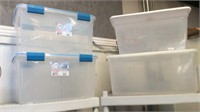 Four clear plastic totes