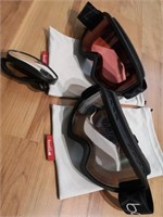 Two bollé goggles and hand mirror