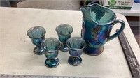 Carnival glass pitcher and glasses