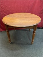 Round top walnut dining table on turned legs