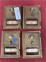 Four bronze postal box door hardware