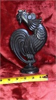 Iron rooster figurine on pedestal