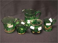 Five pieces of green souvenir glass, some with