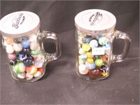 Two glass jars of marbles