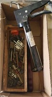 Caulk gun, wood box of bolts
