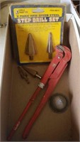 Step drill bits, pipe wrench