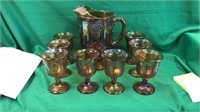 Carnival glass pitcher with 8 tumblers