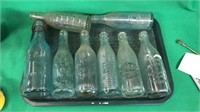 Tray full of 8 antique soda bottles