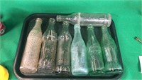 Tray full of 7 antique soda bottles