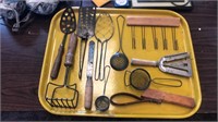 Tray full of antique kitchen utensils