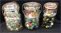 3 JARS OF GLASS MARBLES