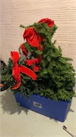 Bin of decorated faux Christmas trees