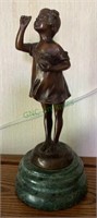 Heavy bronze girl statue figure on a green