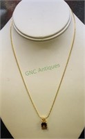 Marked 14k 16 inch gold necklace with emerald