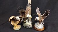 Three eagle statuettes