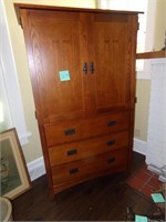 Wood Entertainment Center and Vase of Flowers