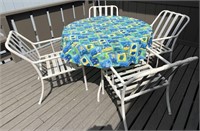 Glass top patio table with four chairs