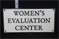 Cast iron Women's Evaluation Center sign