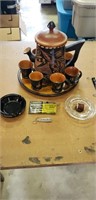 2 ash trays, wooden pitcher with 6 lil cups on a