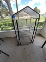 Small plastic patio greenhouse