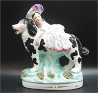 Staffordshire figure of a girl on a spaniel dog