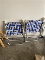 two folding metal lawn chairs