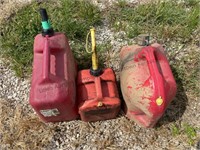 3 plastic gas containers.