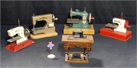 Group of vintage child toy manual sewing machines: